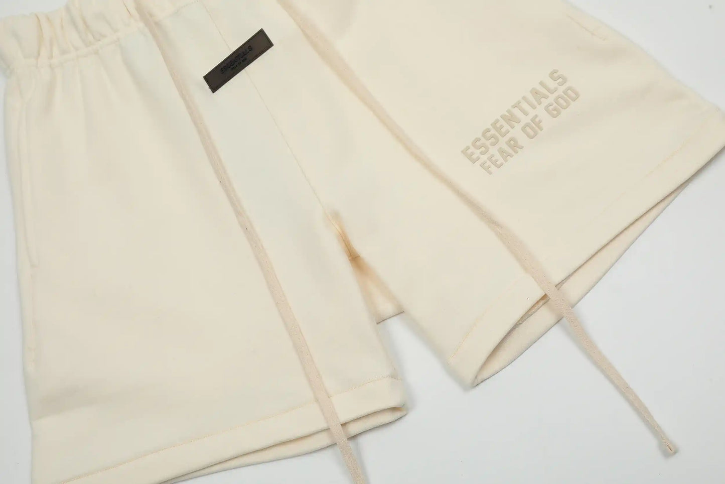 Fear of God Essentials Cloud Dance fleece shorts in neutral tone with tonal logo and relaxed silhouette