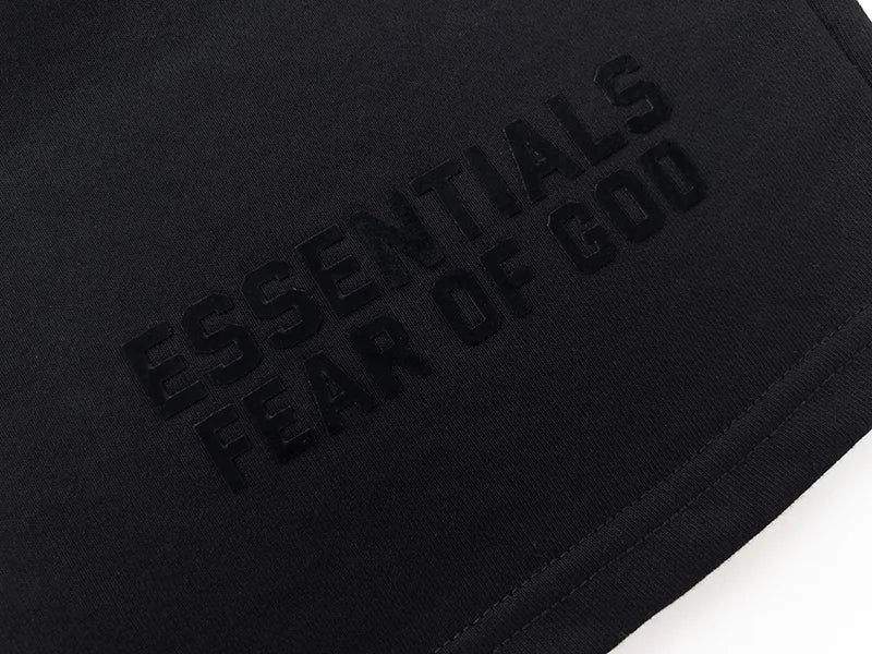 Fear of God Essentials black fleece shorts with tonal logo and core streetwear fit