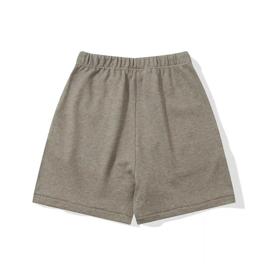 Fear of God Essentials Almond Frost fleece shorts in warm neutral tone with tonal logo and relaxed fit