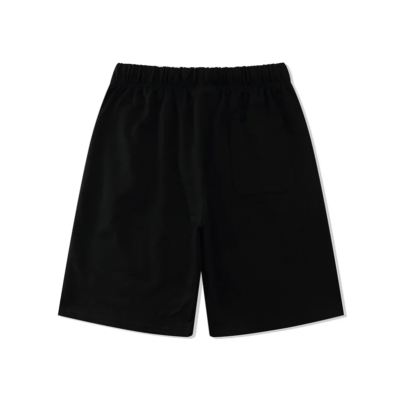 Fear of God Essentials black fleece shorts with tonal logo and relaxed streetwear fit
