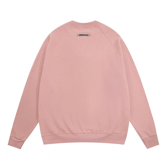 Alt: Fear of God Essentials pink sweatshirt back view with Essentials logo