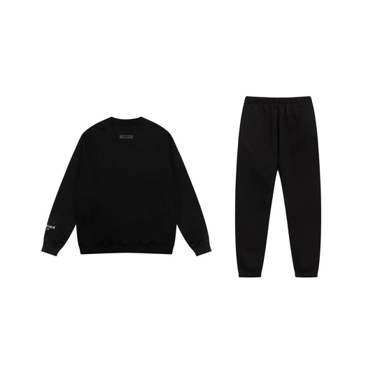 Essentials tracksuit black angled view relaxed fit crewneck set