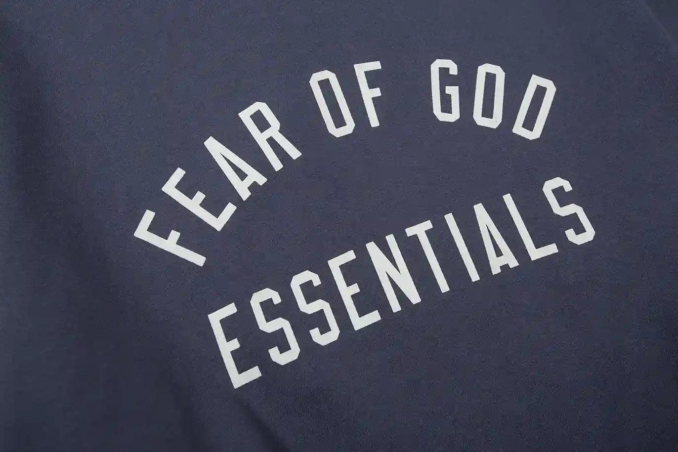 Fear of God Essentials blue hoodie hood label detail