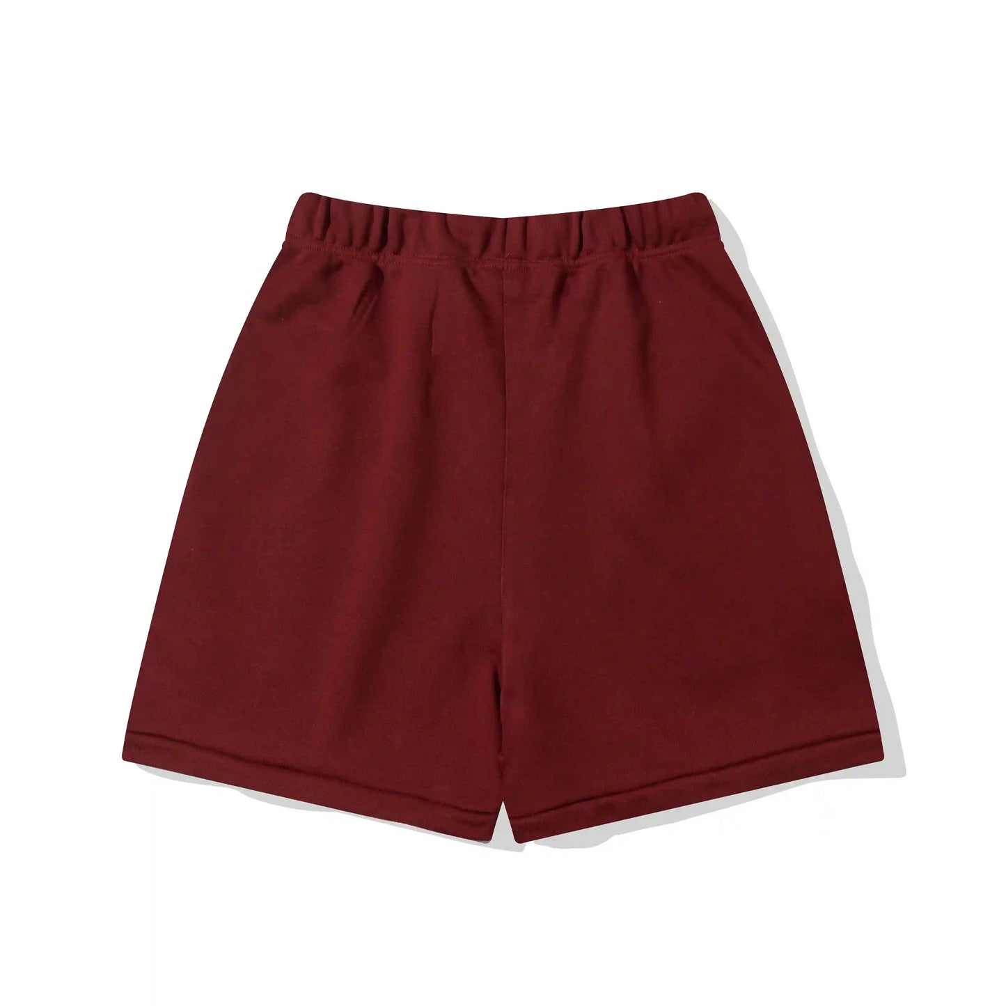 Fear of God Essentials red fleece shorts with tonal branding and relaxed silhouette