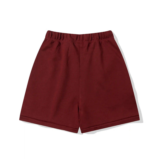 Fear of God Essentials red fleece shorts with tonal branding and relaxed silhouette