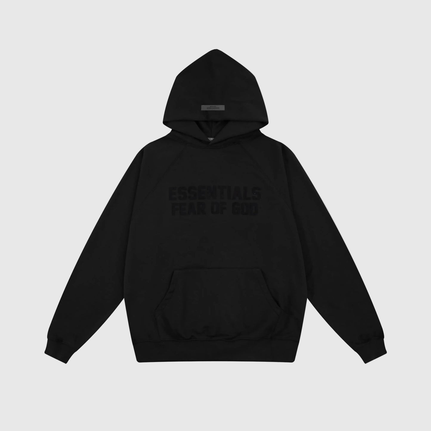 Fear of God Essentials black hoodie front view with rubberized front bar branding