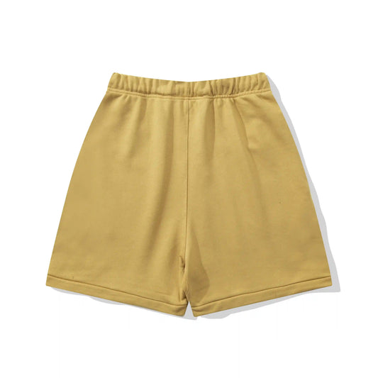 Fear of God Essentials Garden Yellow fleece shorts with tonal branding and relaxed streetwear fit