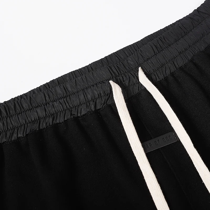 Fear of God Essentials black fleece shorts with tonal branding and modern relaxed fit