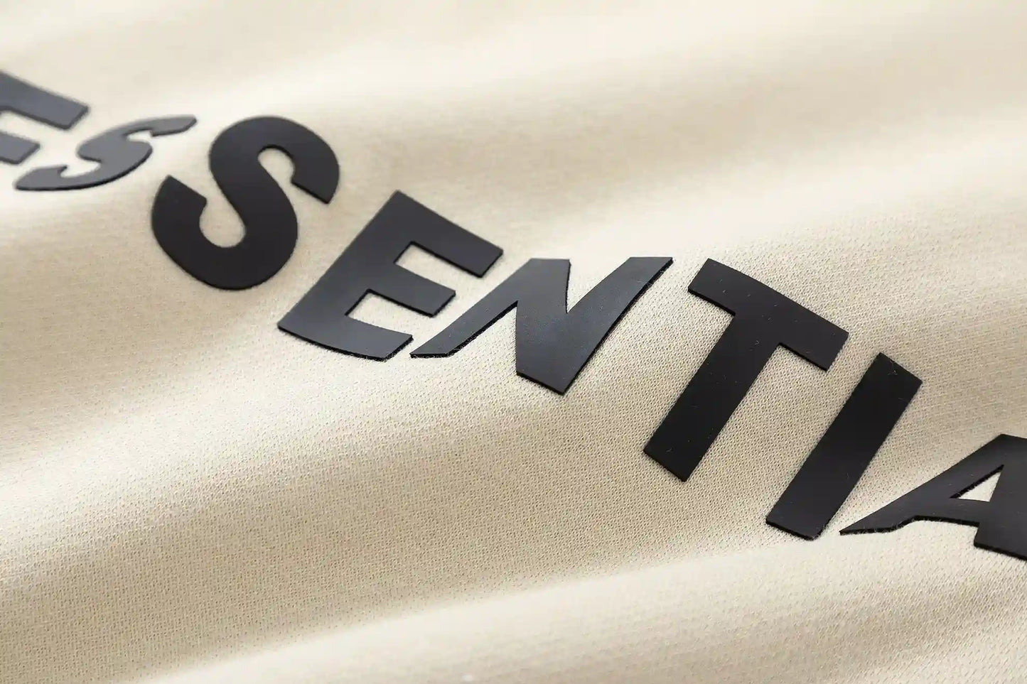 Fear of God Essentials light cream hoodie hood label detail