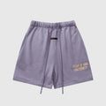 Fear of God Essentials pastel purple fleece shorts with tonal branding and relaxed fit