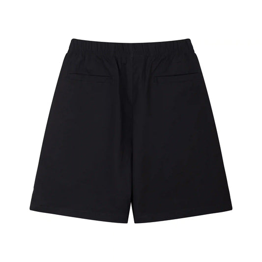Fear of God Essentials black fleece shorts with tonal logo and relaxed streetwear fit