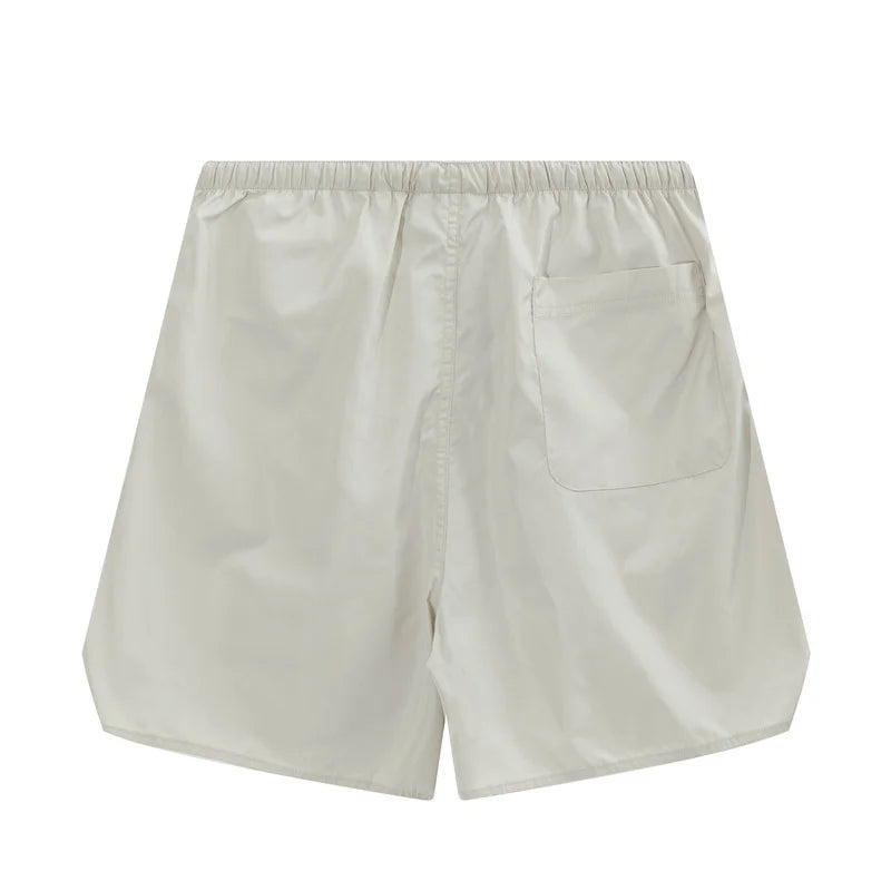 Fear of God Essentials Cloud Dance fleece shorts relaxed fit side view