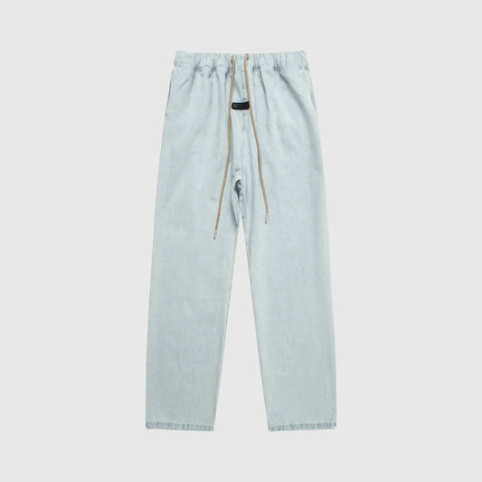 Essentials denim blue relaxed pants by Fear of God front view