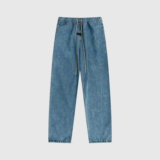 Essentials denim blue relaxed pants by Fear of God front view