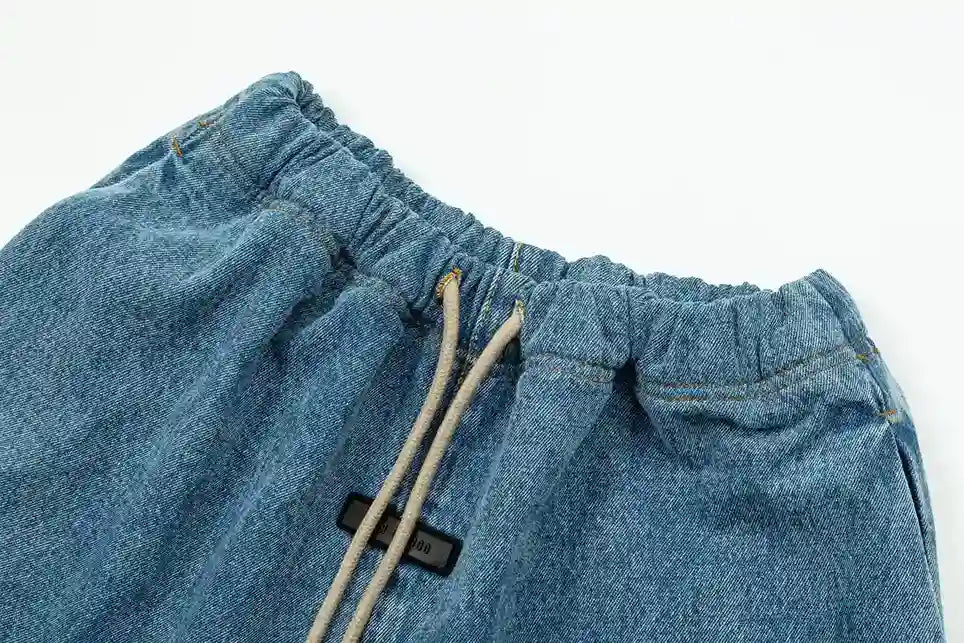 Premium fabric detail on denim blue pants by Fear of God