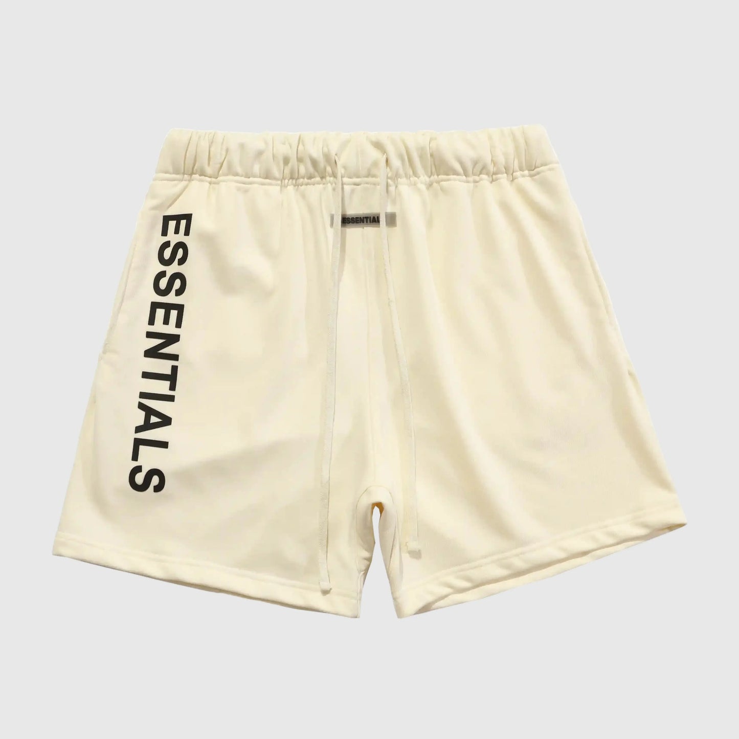 Fear of God Essentials light cream fleece shorts with tonal branding and relaxed fit