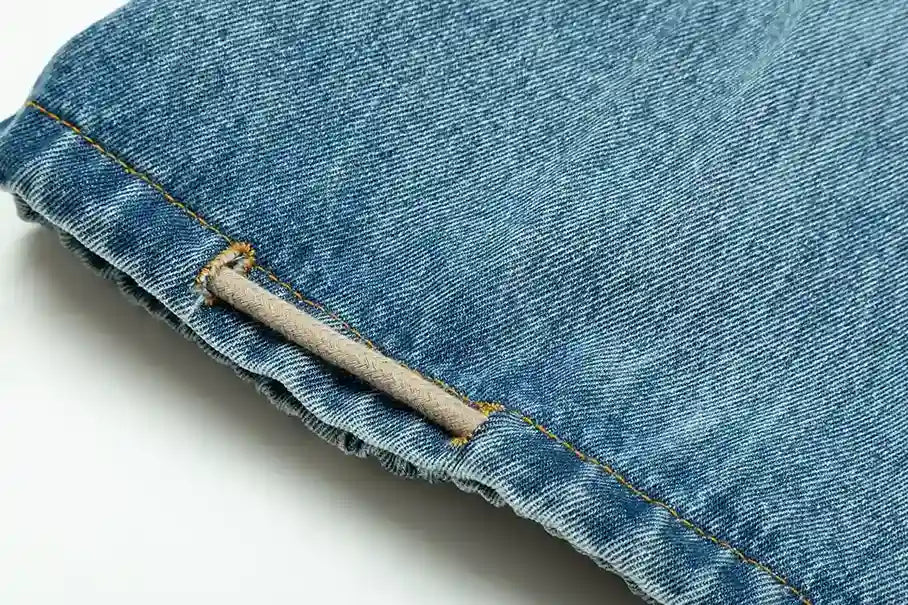 Functional side pocket detail on denim blue pants by Fear of God