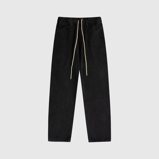 Essentials denim black relaxed pants by Fear of God front view