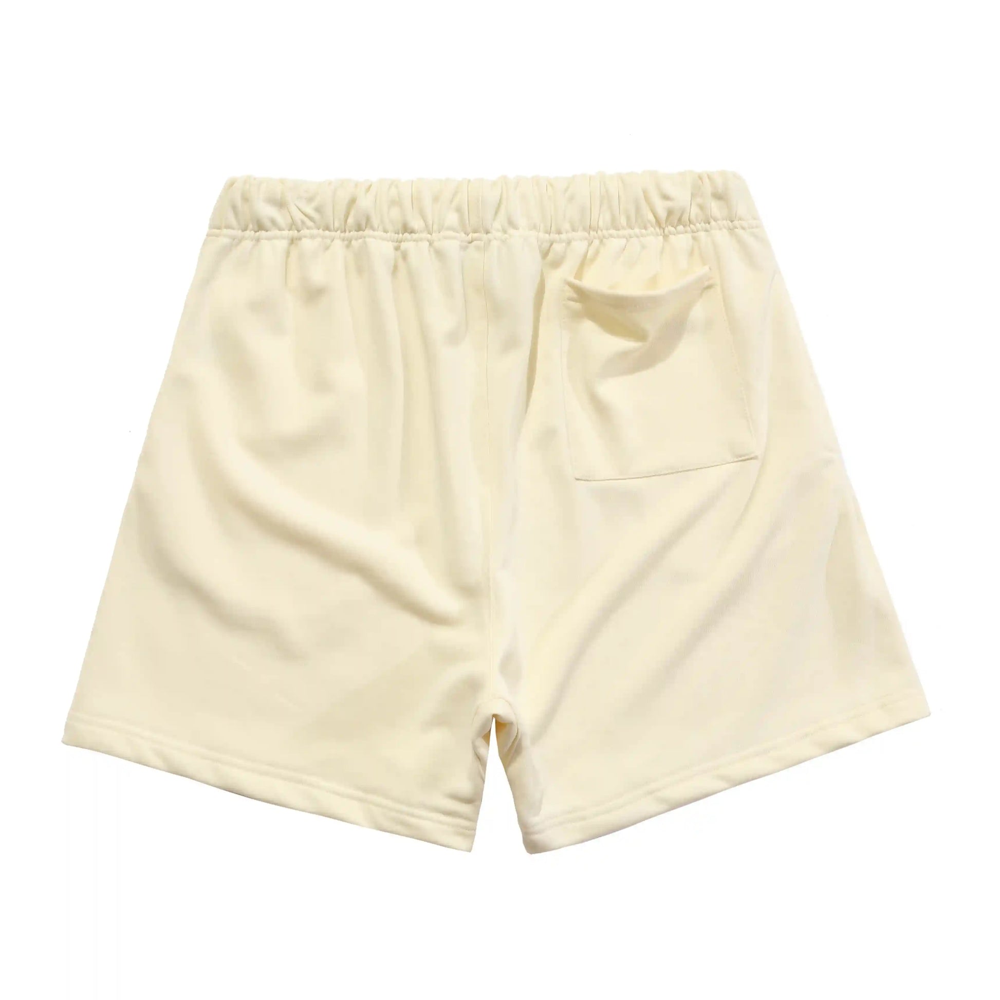 Fear of God Essentials light cream fleece shorts with tonal branding and relaxed fit