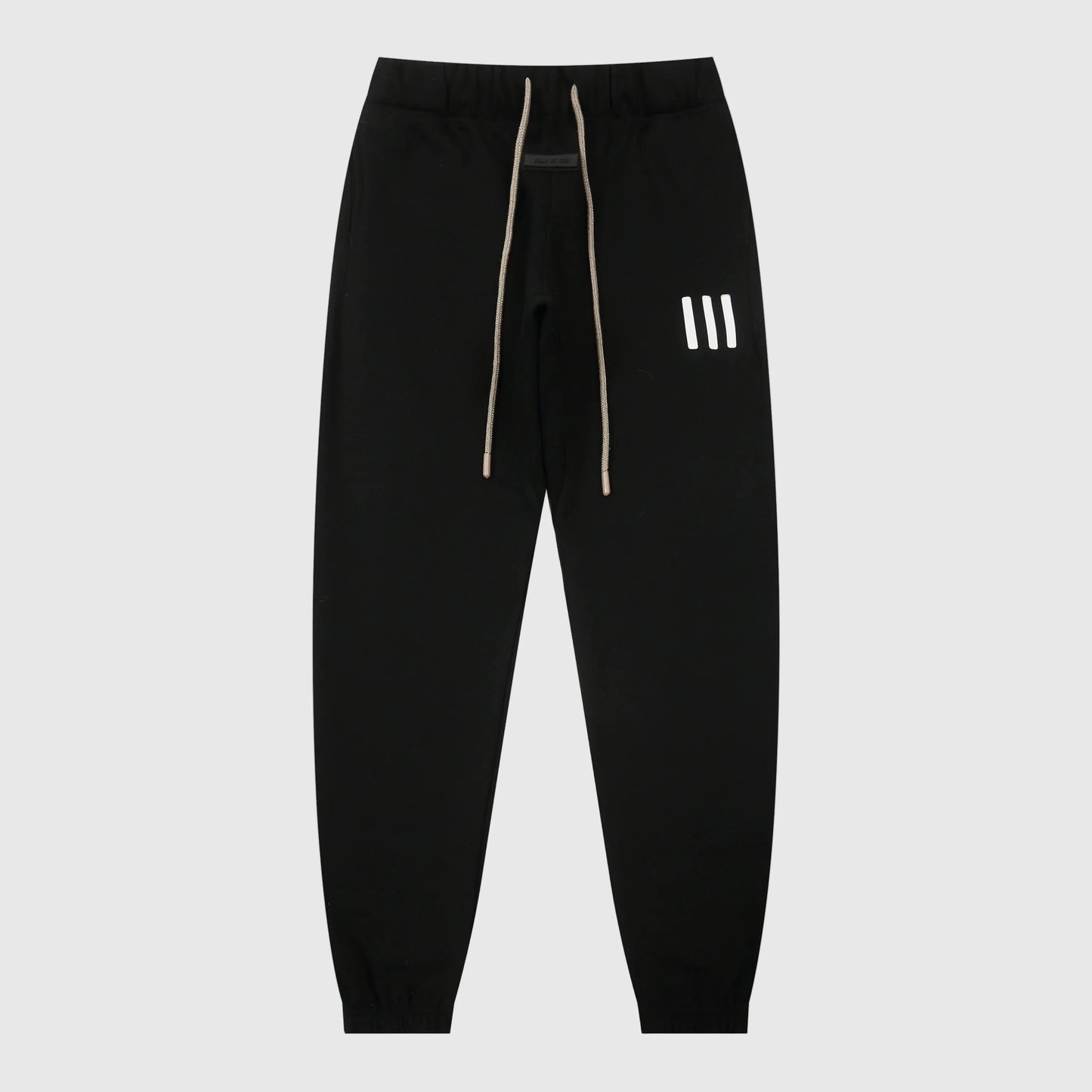 Essentials black core elevated street fleece sweatpants by Fear of God front view