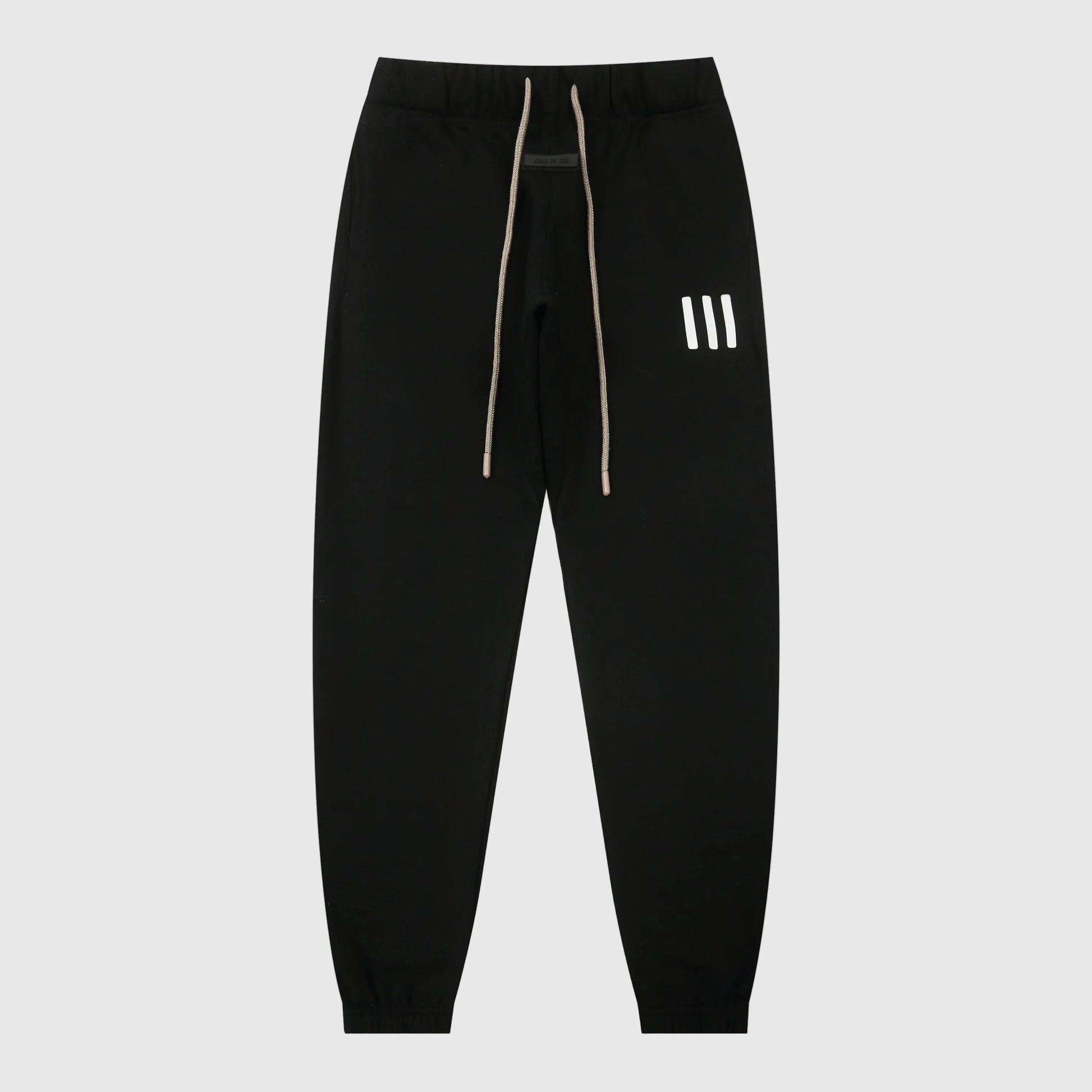 Essentials black core elevated street fleece sweatpants by Fear of God front view