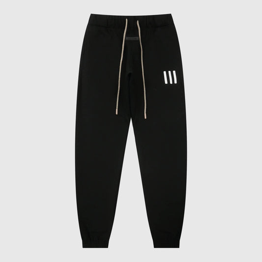 Essentials black core elevated street fleece sweatpants by Fear of God front view