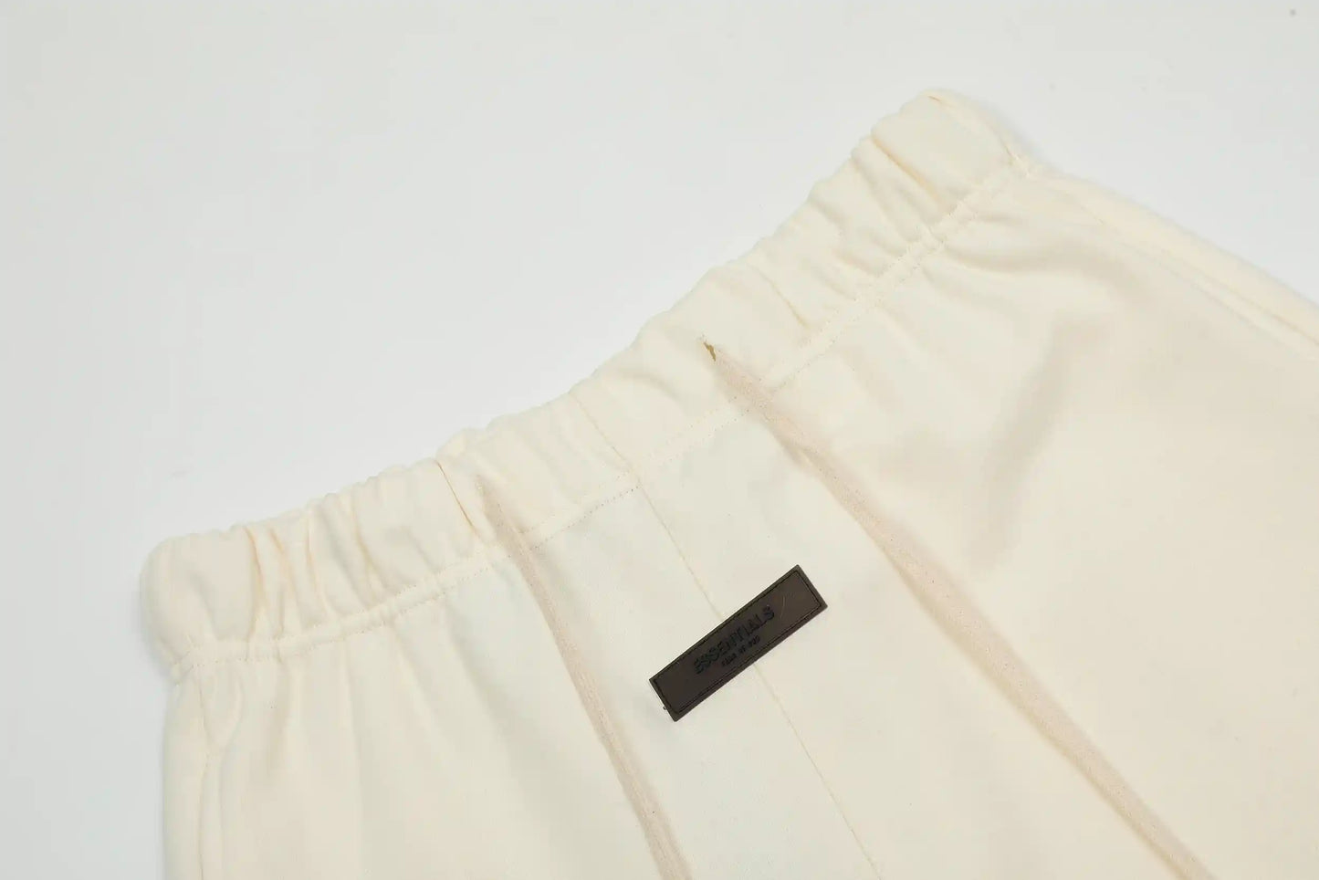 Fear of God Essentials Cloud Dance fleece shorts in neutral tone with tonal logo and relaxed silhouette