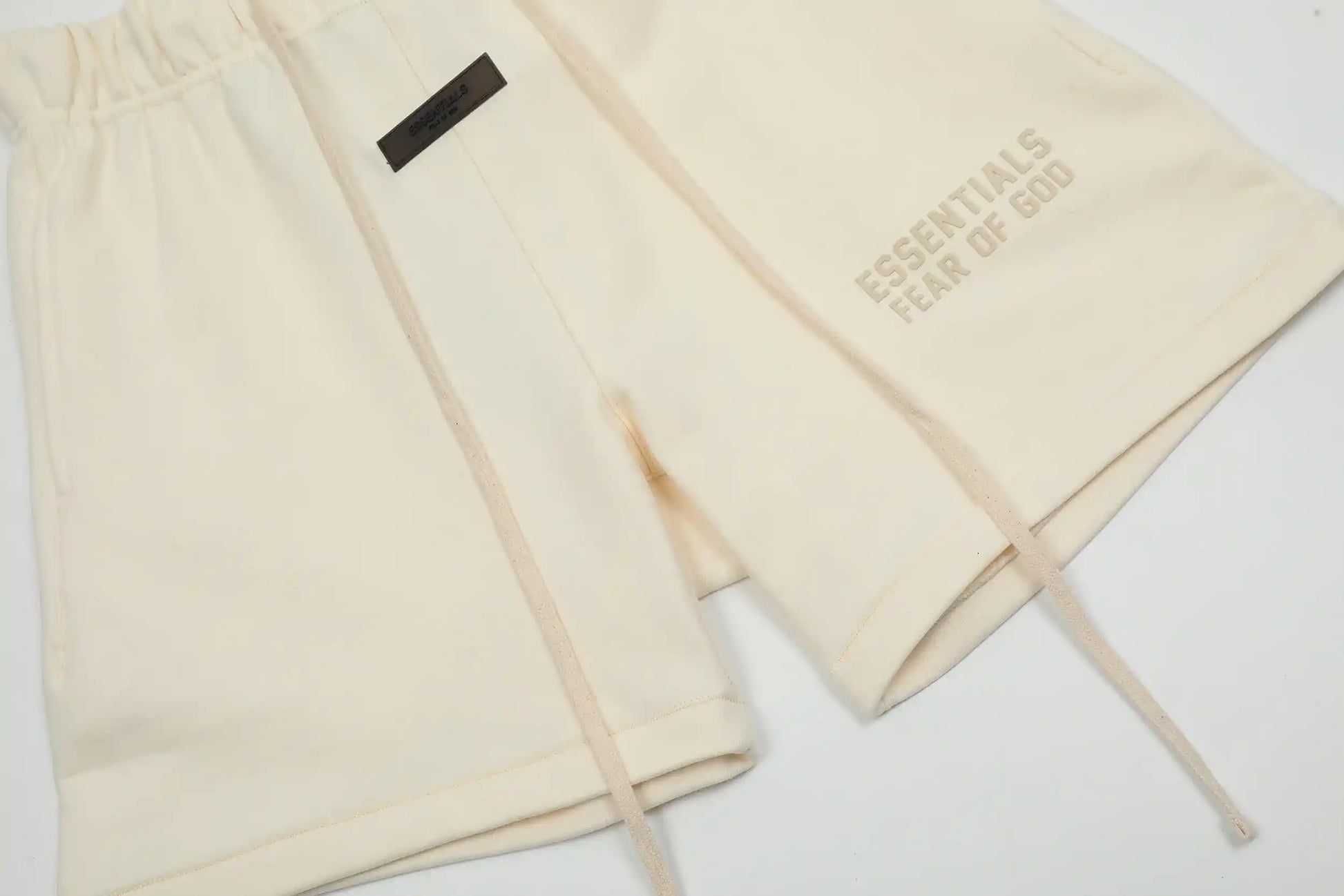 Fear of God Essentials Cloud Dance fleece shorts in neutral tone with tonal logo and relaxed silhouette