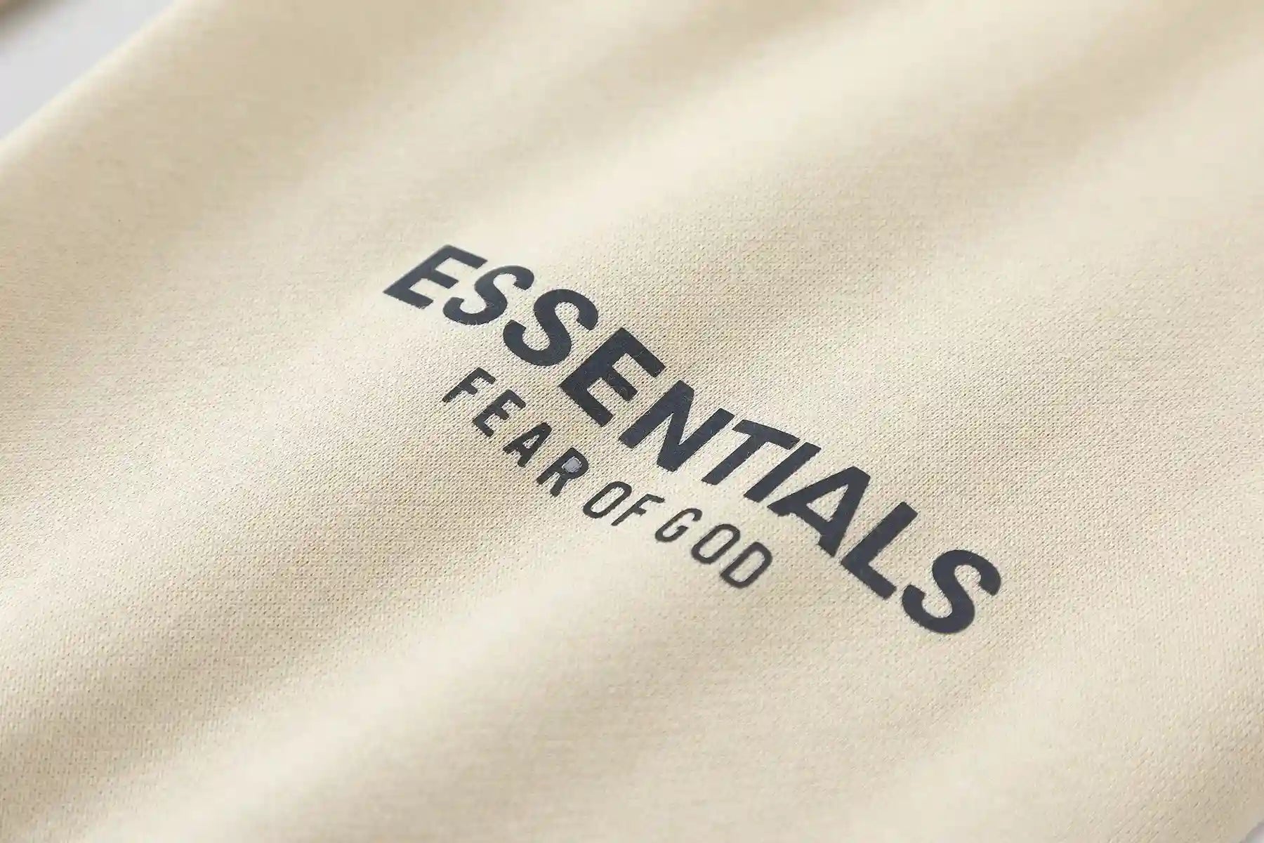 Jogger style light cream sweatpants by Fear of God with elastic waistband