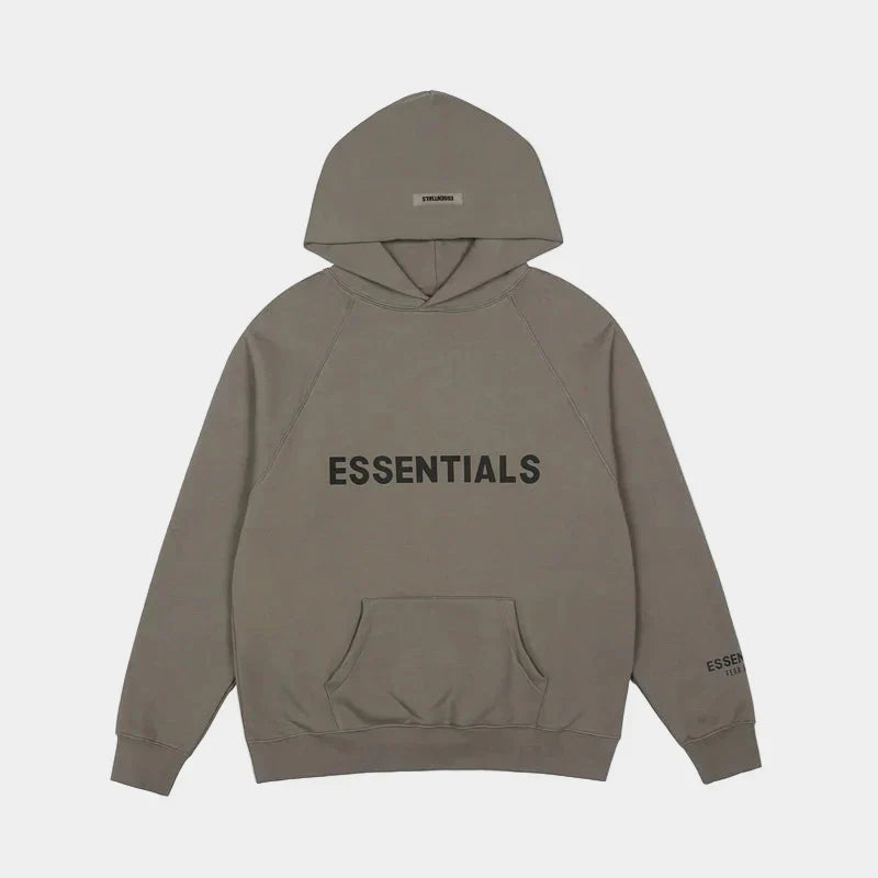 Fear of God Essentials sandstone hoodie front view with rubberized Black Bar branding