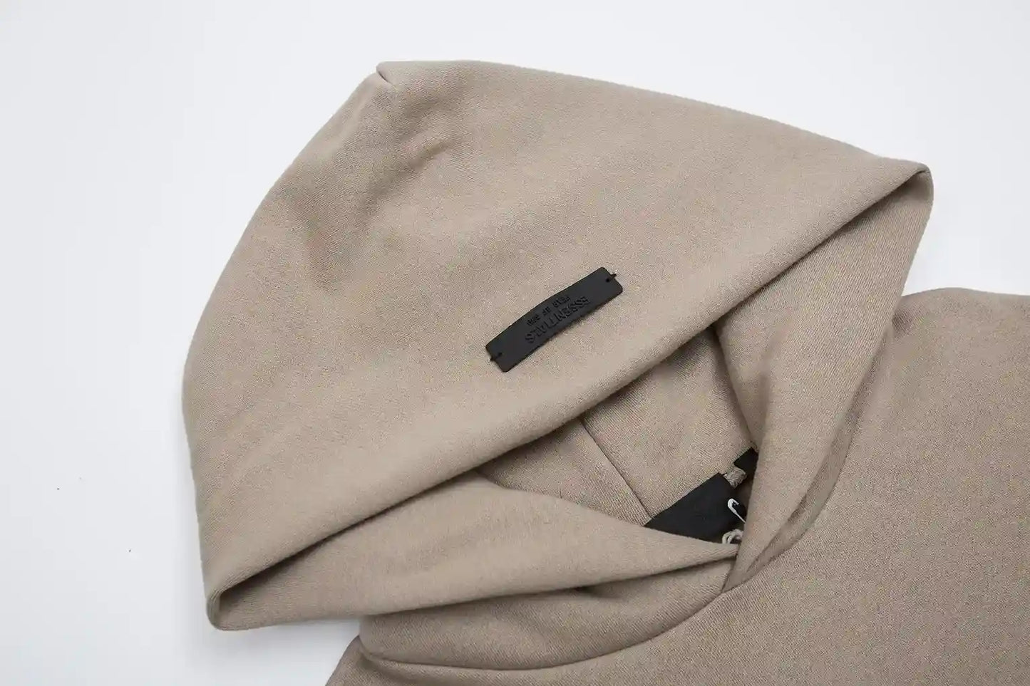 Close-up of sandrift fleece texture and Essentials Black Bar detail
