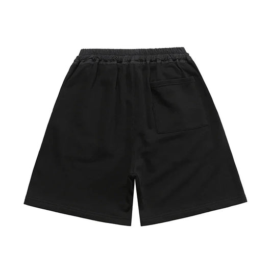 Fear of God Essentials black fleece shorts with tonal branding and relaxed streetwear fit