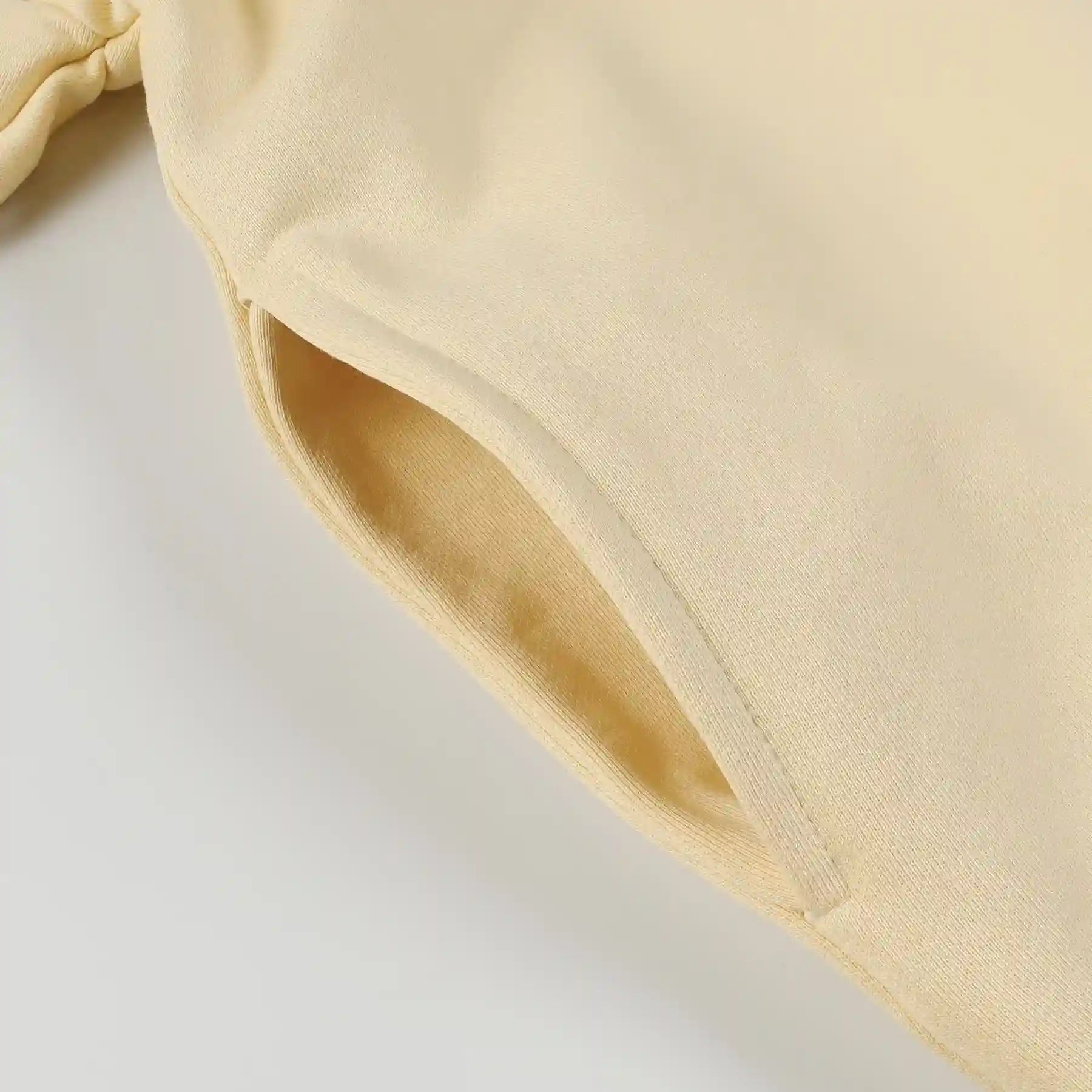 Fear of God Essentials Calm Shell hoodie front view with rubberized black bar branding