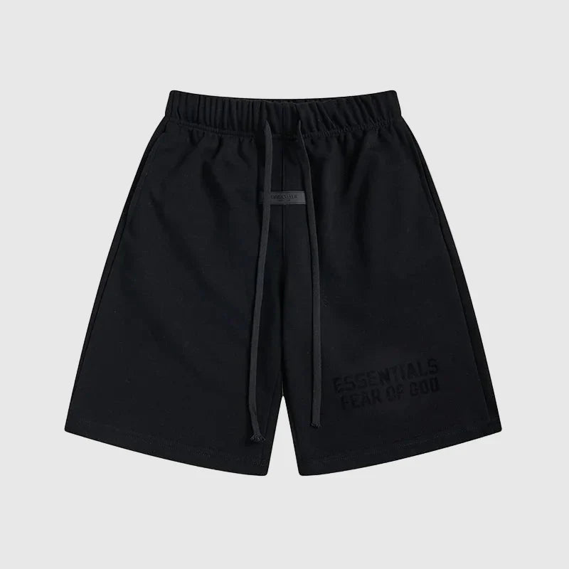 Fear of God Essentials black fleece shorts with tonal logo and core streetwear fit
