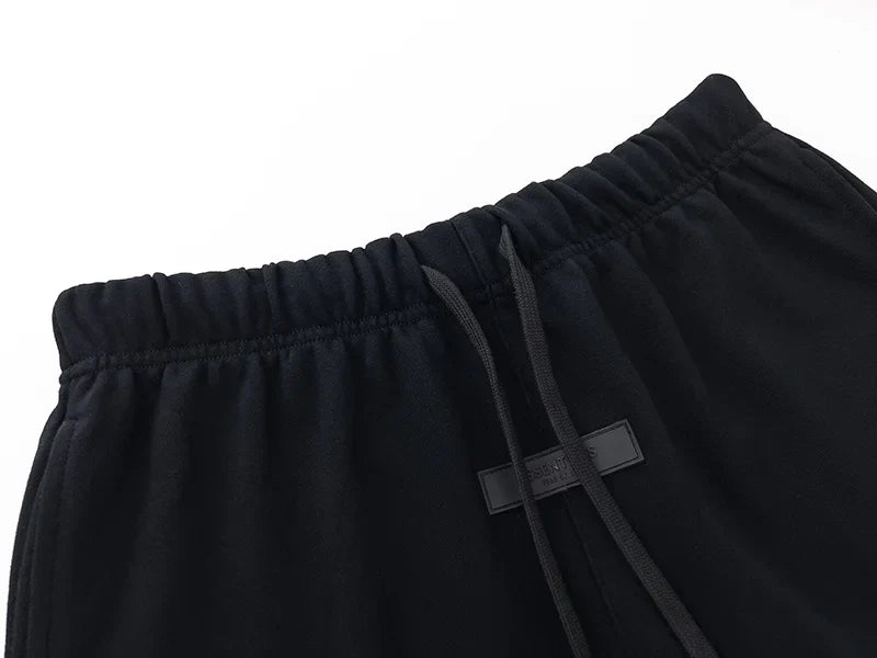Fear of God Essentials black fleece shorts with tonal logo and core streetwear fit