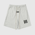 Fear of God Essentials Light Heather Oatmeal shorts in fleece with drawstring waistband and tonal branding