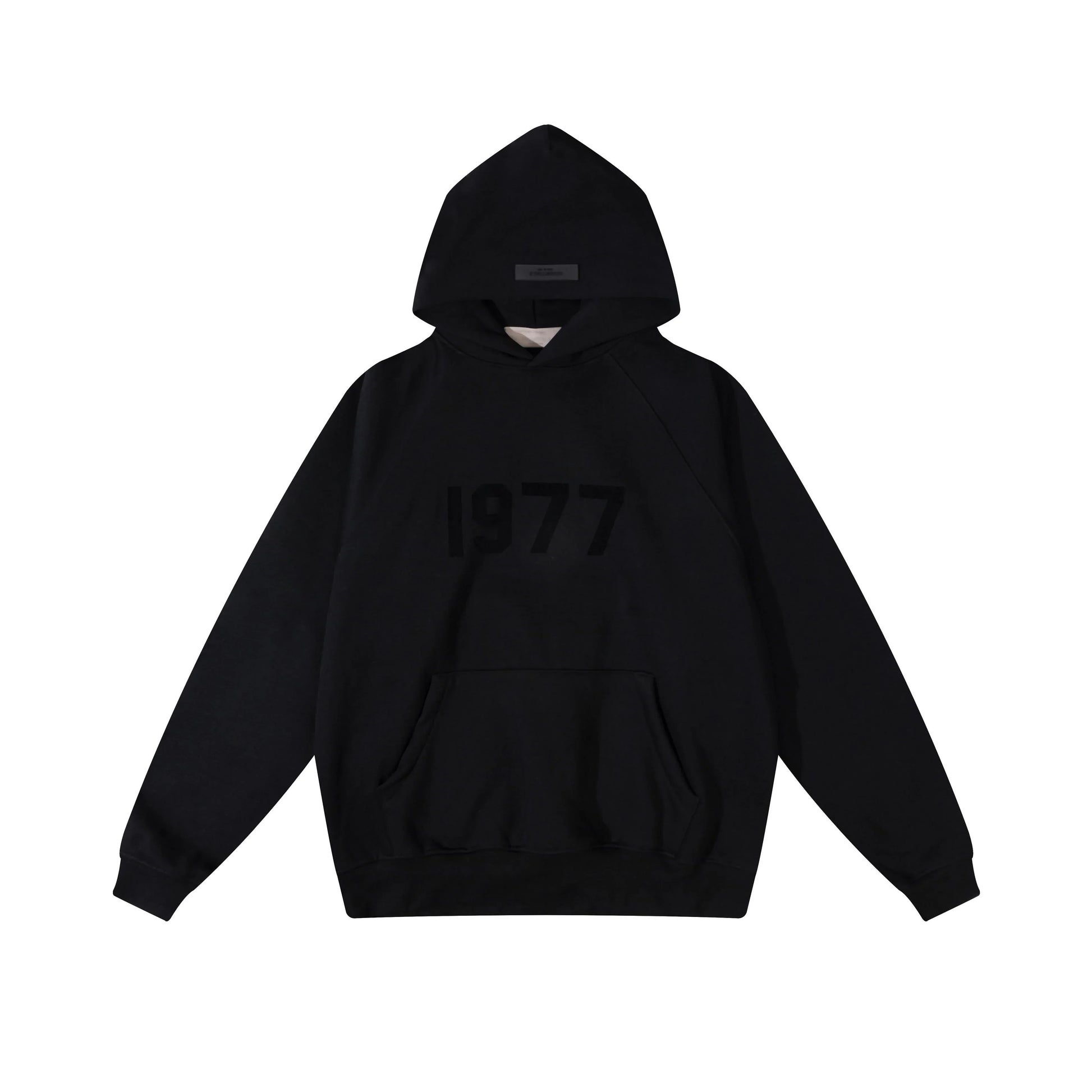 Black Essentials hoodie center front rubberized black bar branding close-up