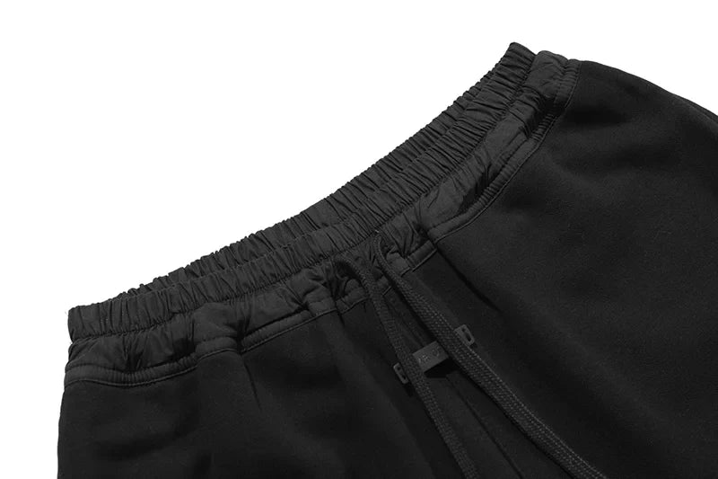 Fear of God Essentials black fleece shorts with tonal branding and relaxed streetwear fit