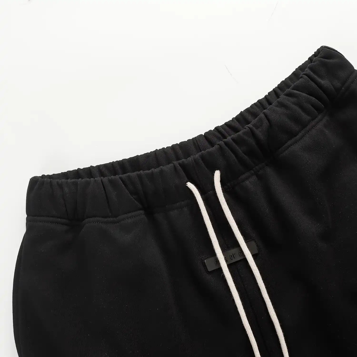Fear of God Essentials black fleece shorts with tonal logo and oversized fit