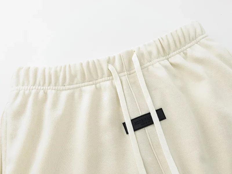 Fear of God Essentials Cloud Dance shorts in soft white fleece with relaxed fit and tonal branding
