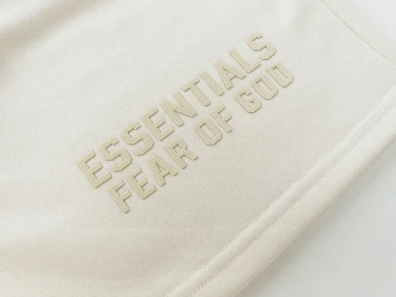 Fear of God Essentials Cloud Dance shorts in soft white fleece with relaxed fit and tonal branding
