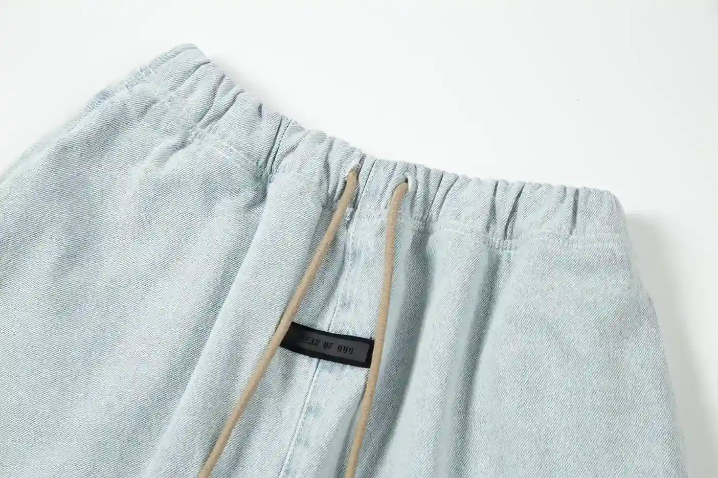 Fear of God Essentials denim blue fleece shorts with tonal logo and relaxed vintage fit