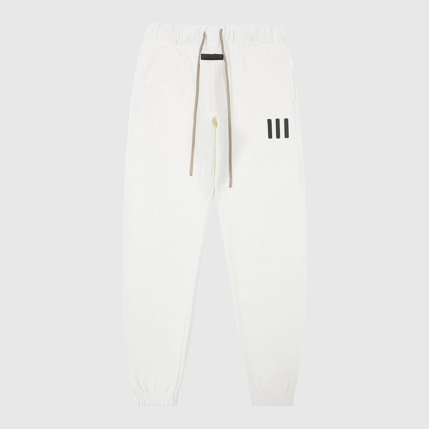 Jogger style eggshell sweatpants by Fear of God with elastic waistband

