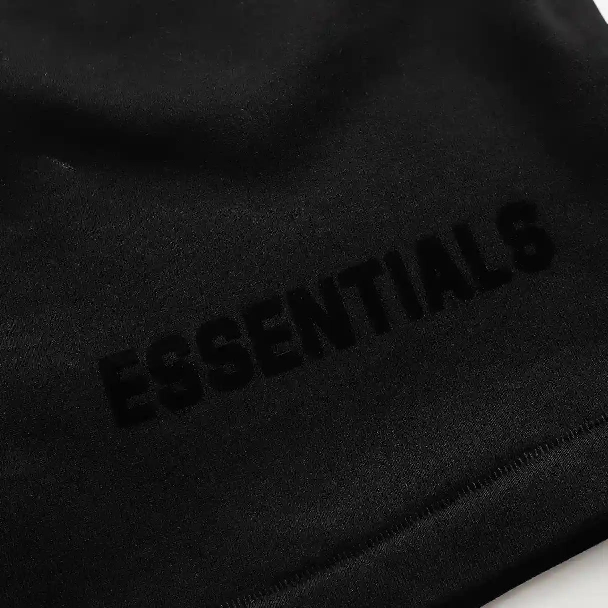 Fear of God Essentials black fleece shorts with tonal logo and oversized fit