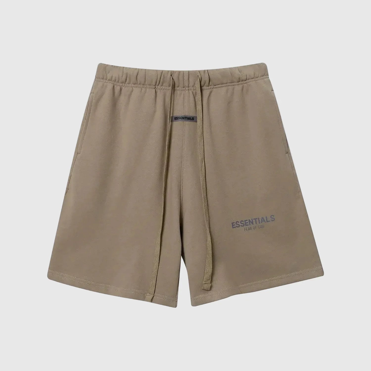 Model wearing Fear of God ESSENTIALS Sandrift shorts in neutral beige color
