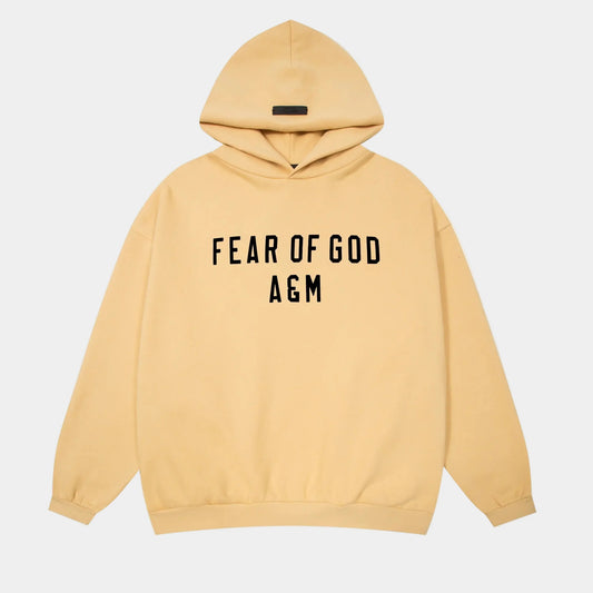 Fear of God Essentials Garden Yellow hoodie front view with rubberized black bar branding