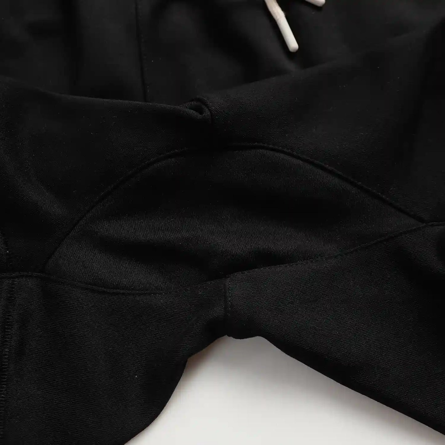 Fear of God Essentials black fleece shorts with tonal logo and oversized fit