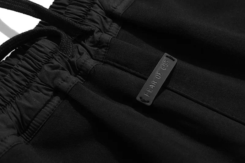 Fear of God Essentials black fleece shorts with tonal branding and relaxed streetwear fit