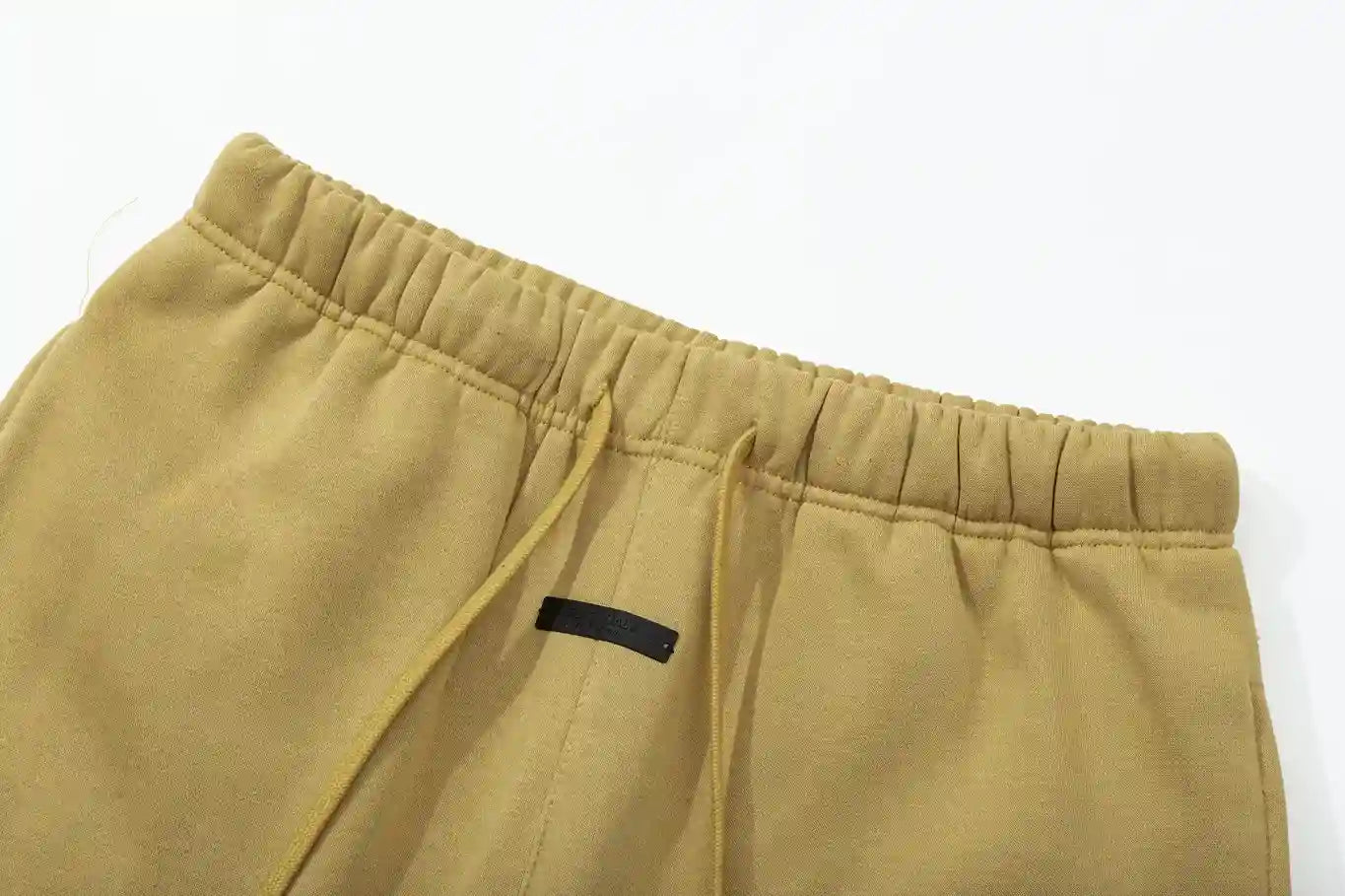 Premium fleece fabric detail on garden yellow sweatpants by Fear of God