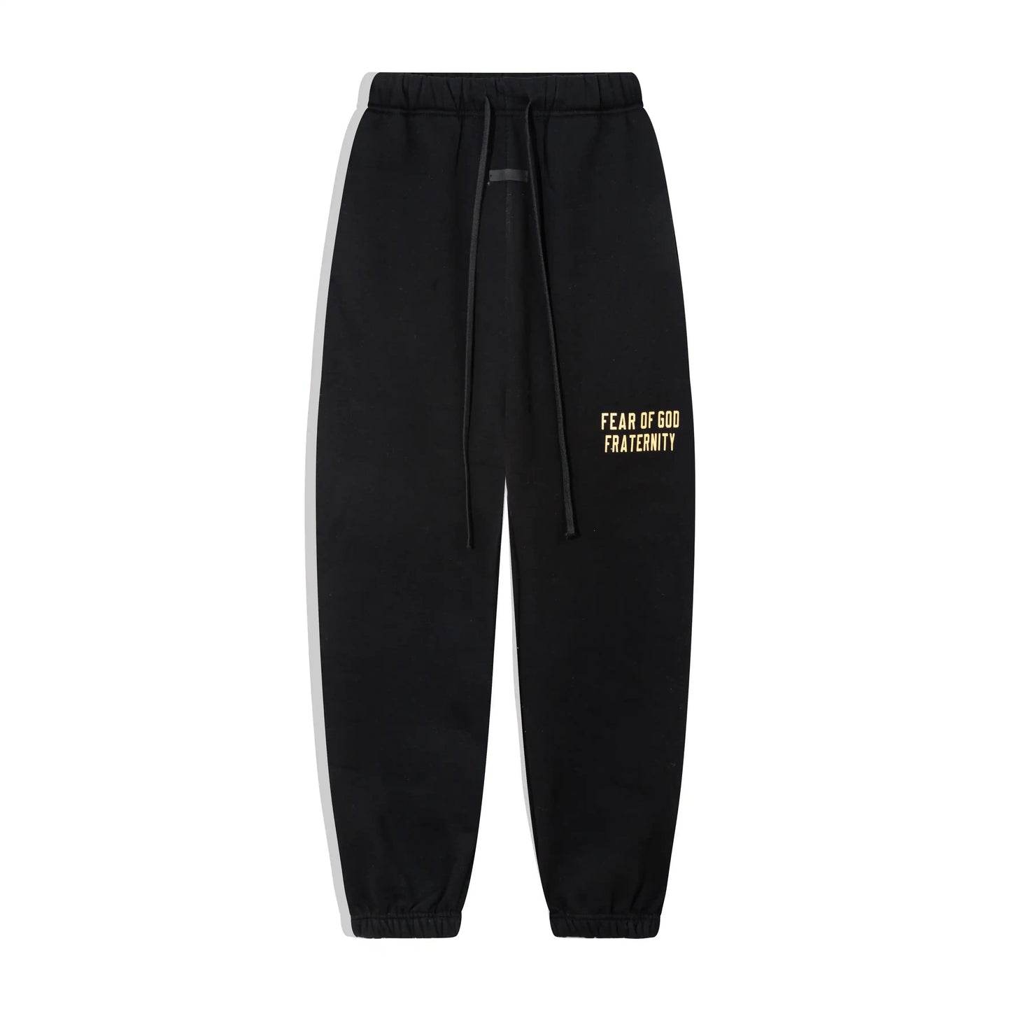 Black Essentials joggers soft-touch rubberized logo on leg close-up